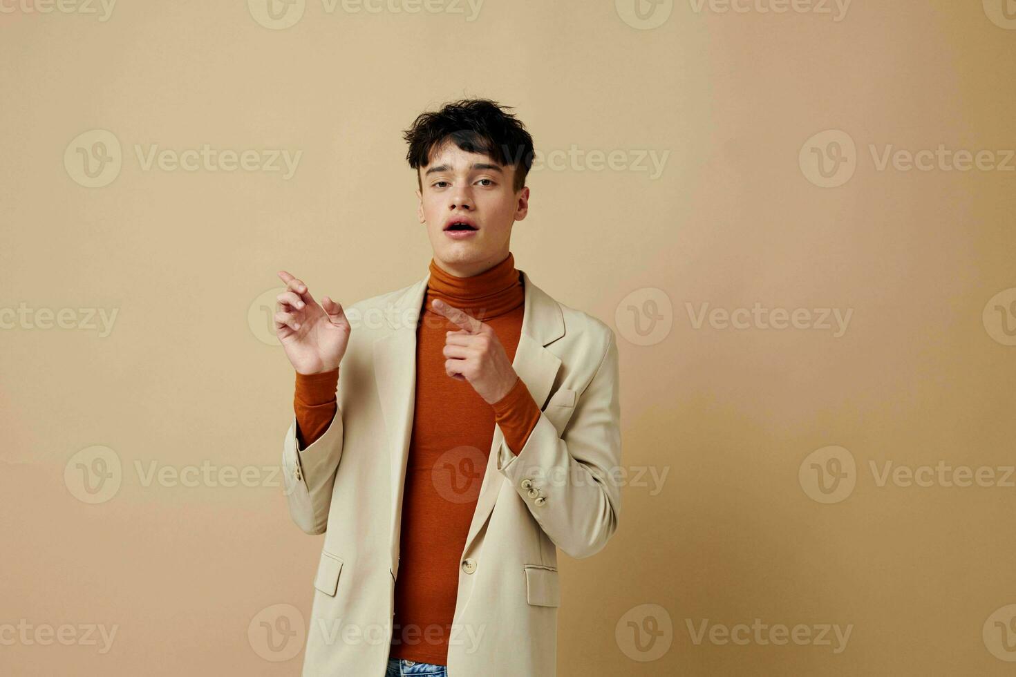 handsome guy posing with a phone in his hands in a jacket elegant style isolated background unaltered photo