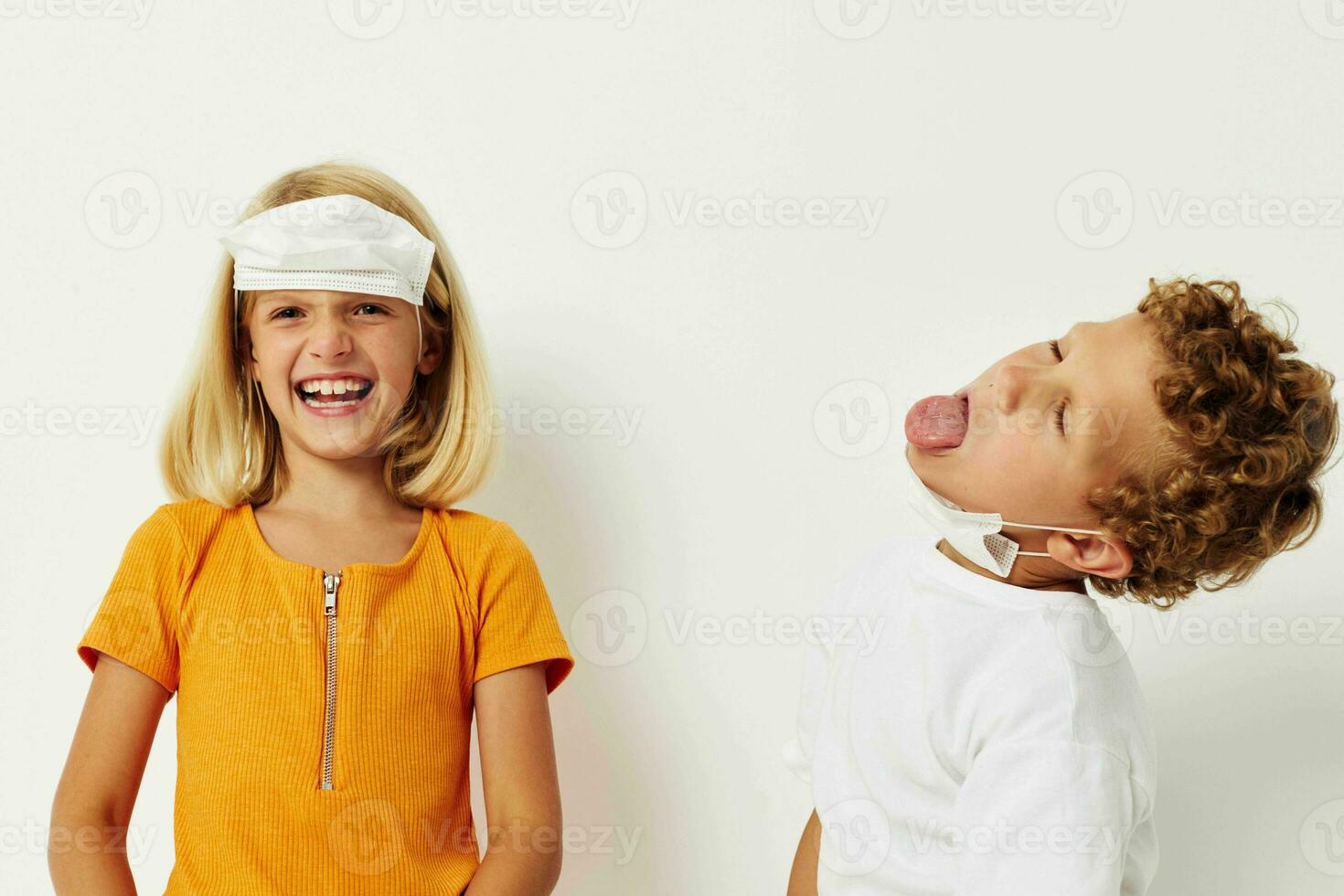 Portrait of cute children fun medical mask stand side by side close-up lifestyle unaltered photo