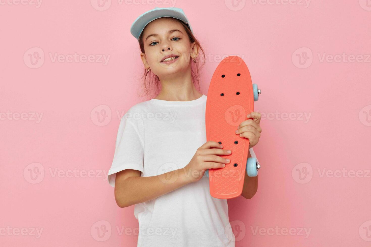 little girl with a skateboard in hand isolated background photo