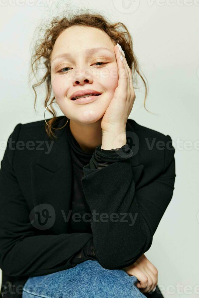 cheerful woman sitting on a chair in a black jacket fashion posing Lifestyle unaltered photo