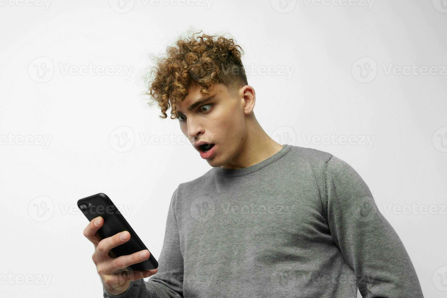 Attractive man talking on the phone posing emotions light background photo
