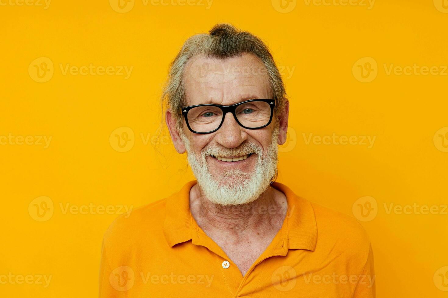 cheerful old man gray beard glasses yellow background photo