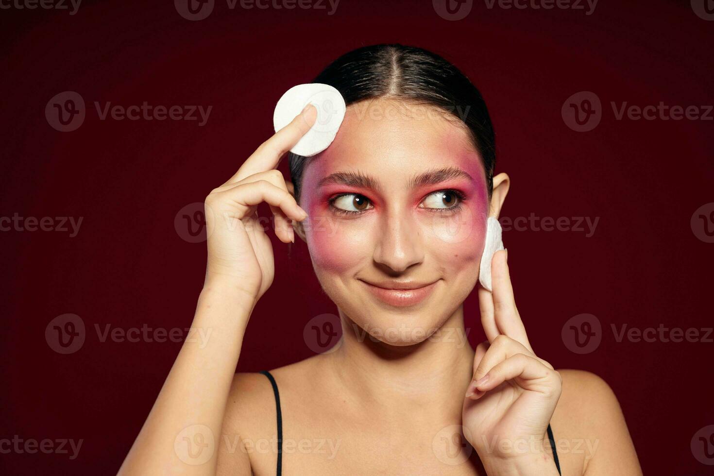 Young beautiful woman cotton pads clean leather bright makeup posing isolated background unaltered photo