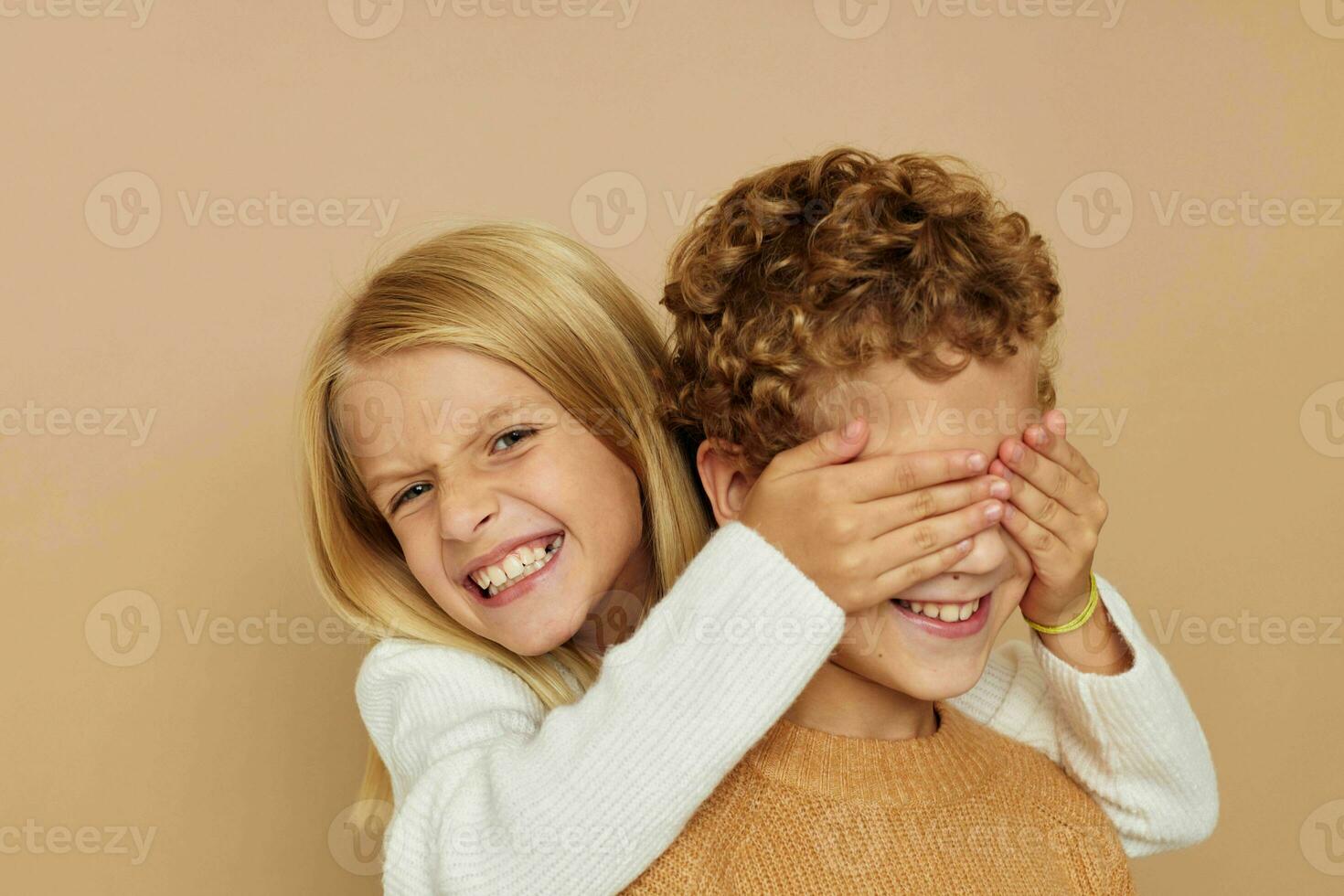 Cute stylish children hug entertainment posing friendship beige background photo