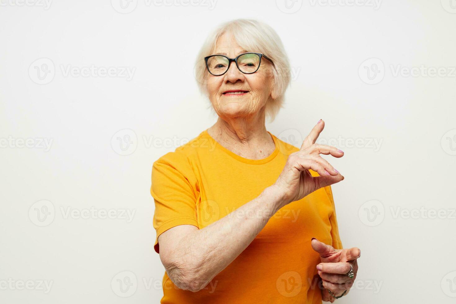 Portrait of an old friendly woman vision problems with glasses isolated background photo