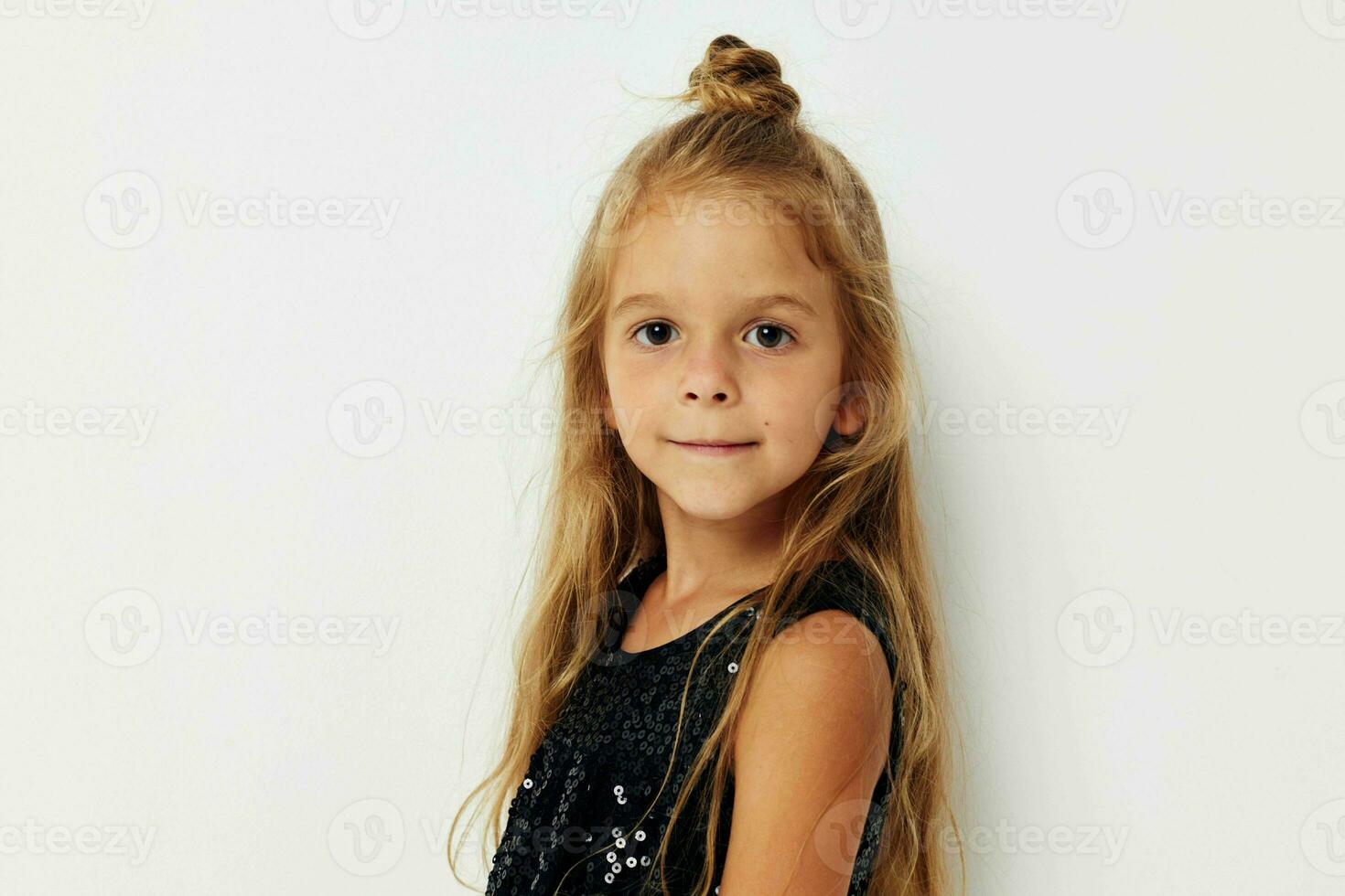 smiling girl in black dress posing light background photo