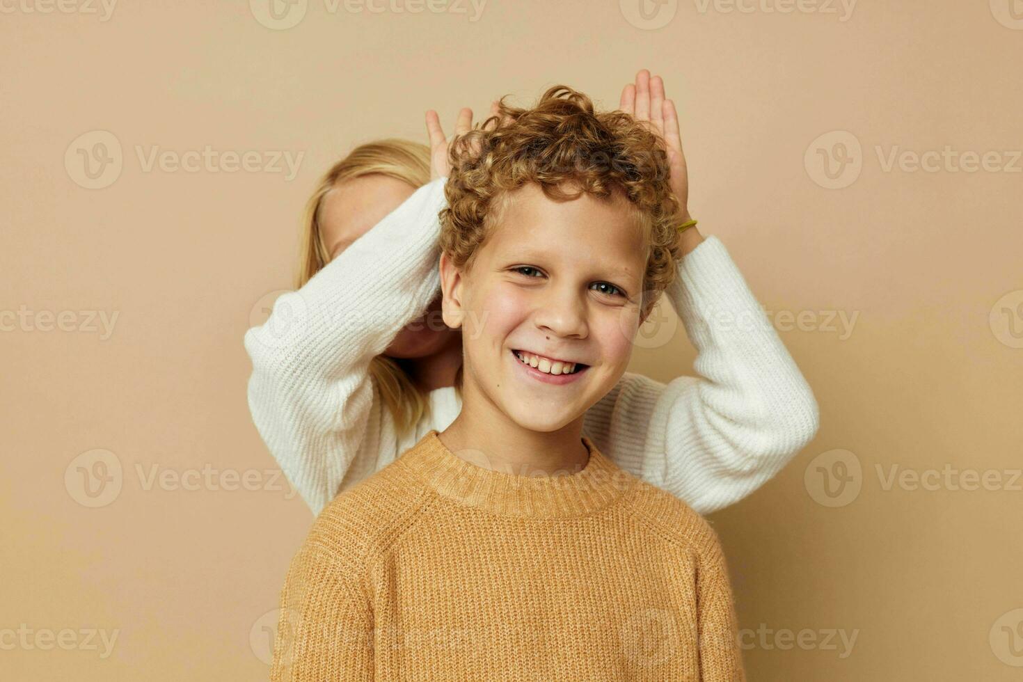 Boy and girl gesticulate with their hands together Lifestyle unaltered photo