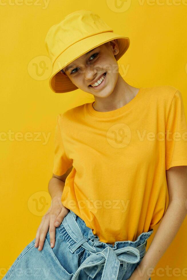 attractive woman in a yellow hat Youth style casual wear yellow background photo