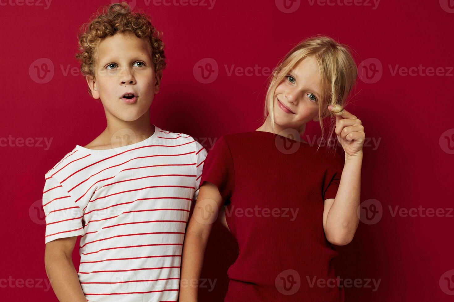 picture of positive boy and girl good mood standing next to posing isolated background photo