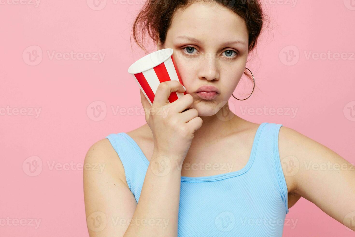 pretty woman with disposable glass posing emotions pink background unaltered photo
