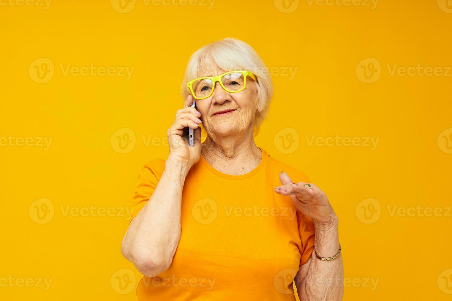 Photo of retired old lady in casual t-shirt communication by phone close-up emotions