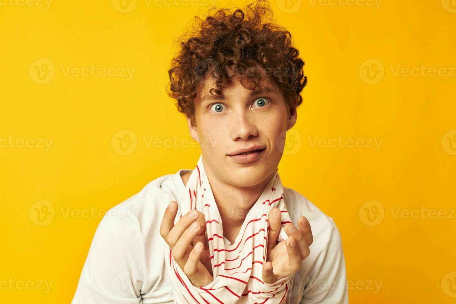 Young curly-haired man striped t shirt posing summer clothing Lifestyle unaltered photo