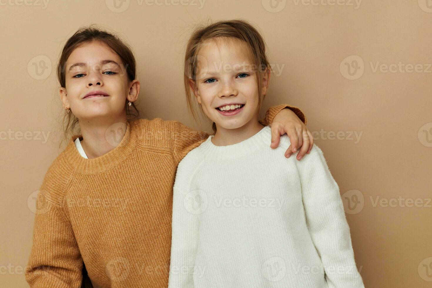 two cute little girls hug friendship lifestyle beige background photo