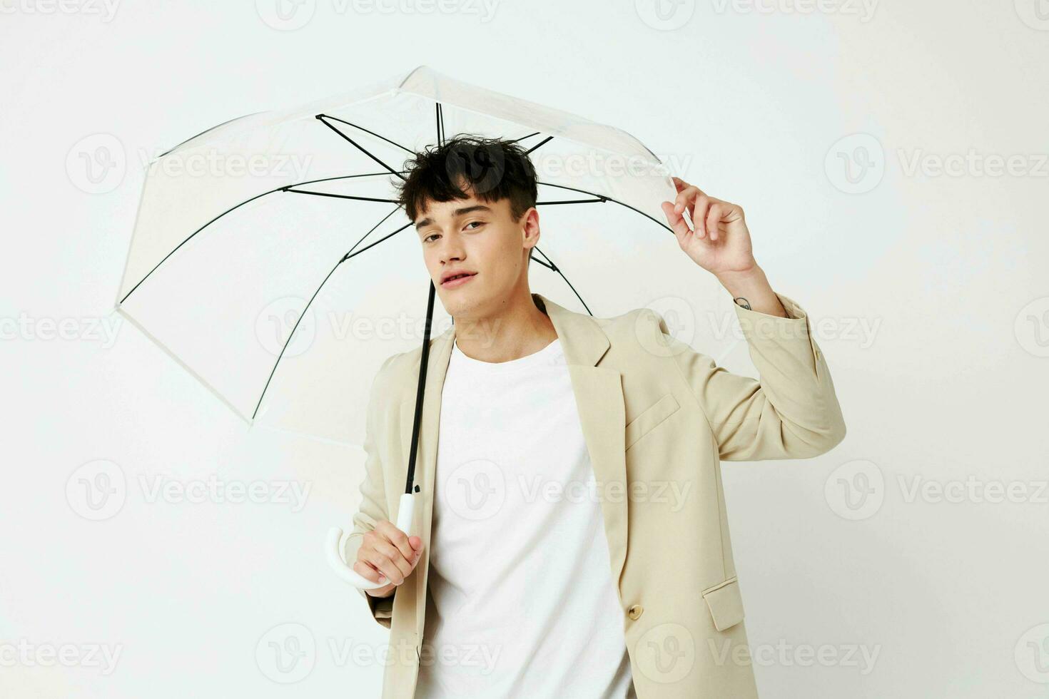handsome guy transparent umbrella a man in a light jacket isolated background unaltered photo