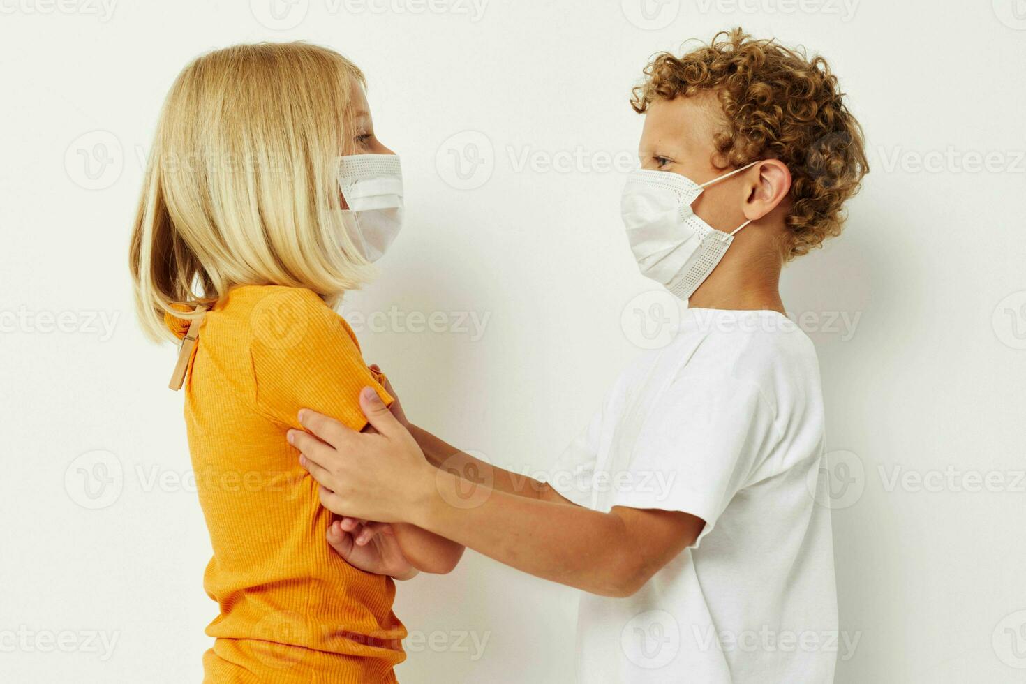 Cute stylish kids fun medical mask stand side by side close-up lifestyle unaltered photo