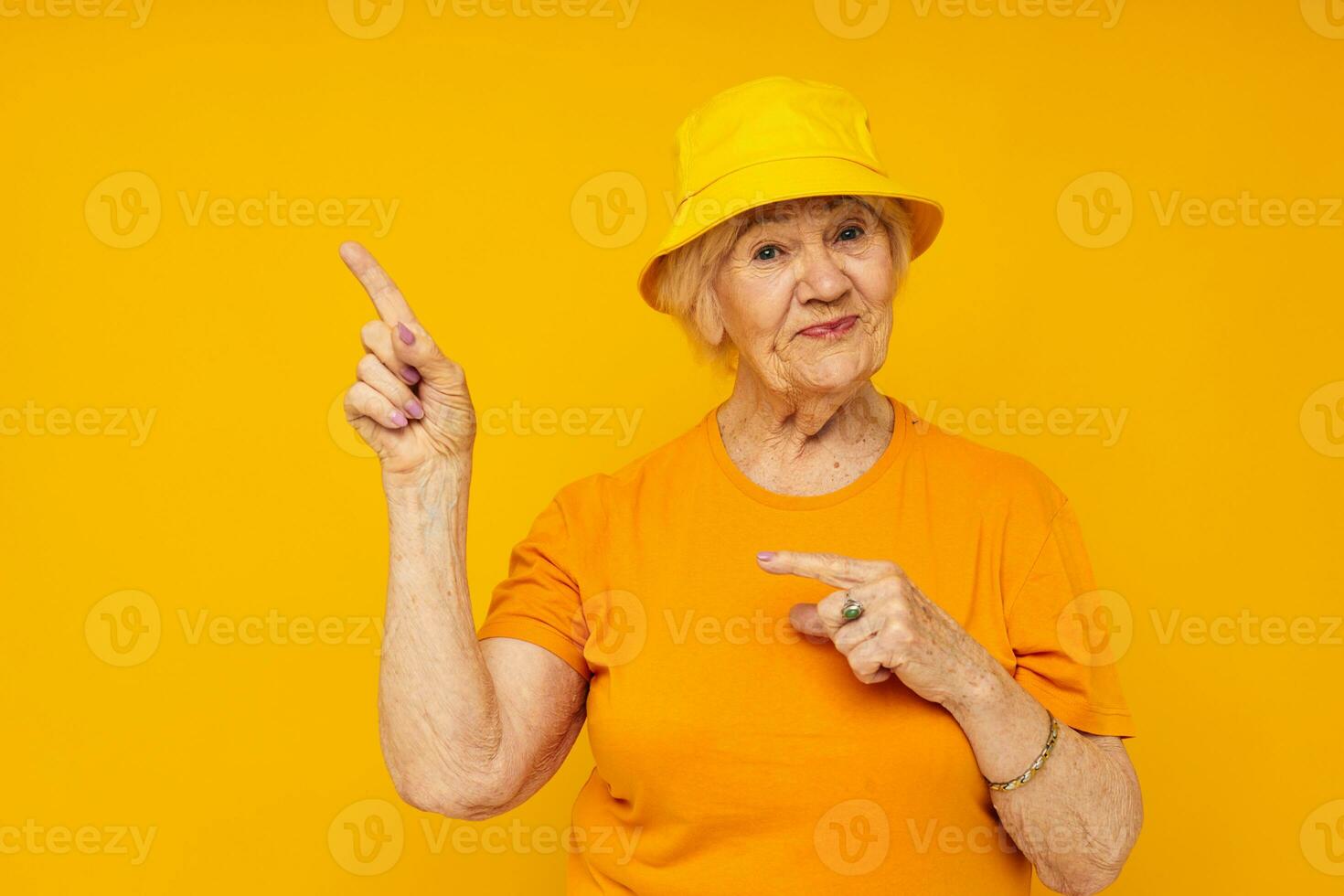 elderly woman in casual t-shirt yellow panama isolated background photo