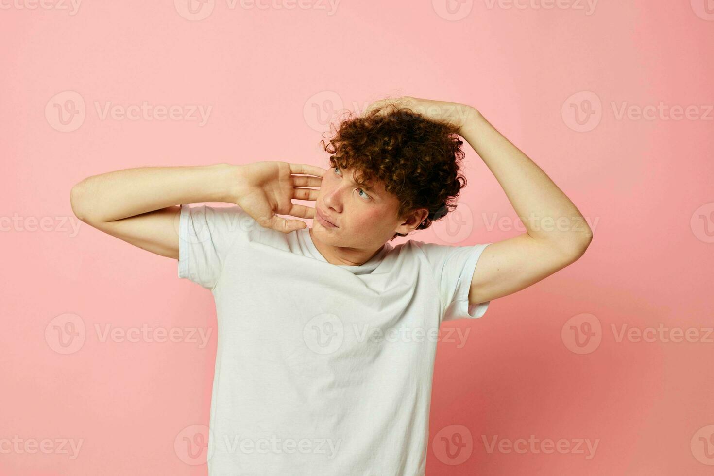 retrato de un joven Rizado hombre posando juventud estilo blanco camiseta aislado antecedentes inalterado foto