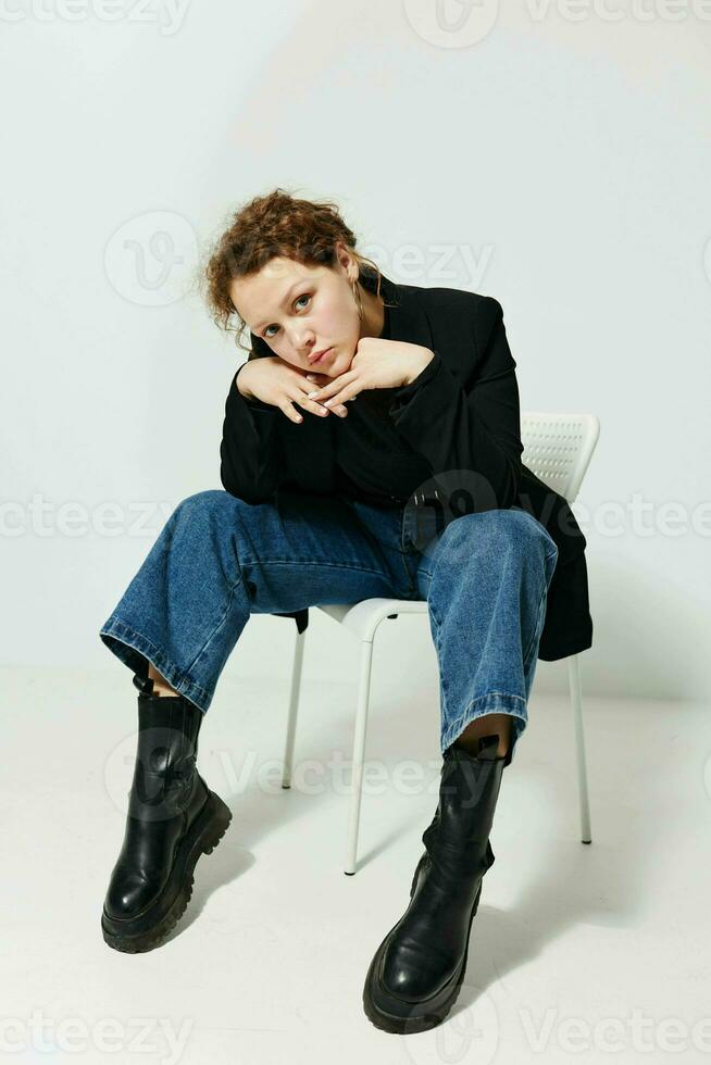 pretty woman black jacket jeans posing light background unaltered photo