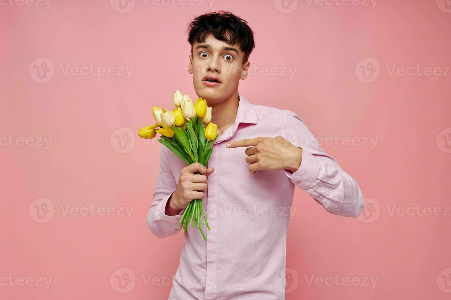portrait of a young man bouquet of flowers date romance posing pink