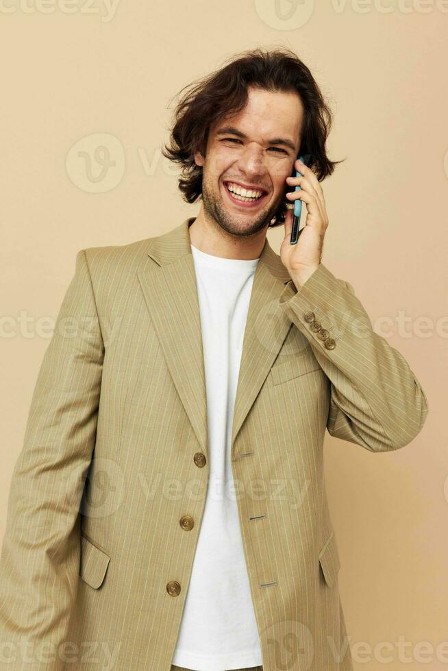 Attractive man communication by phone beige suit elegant style Lifestyle unaltered photo