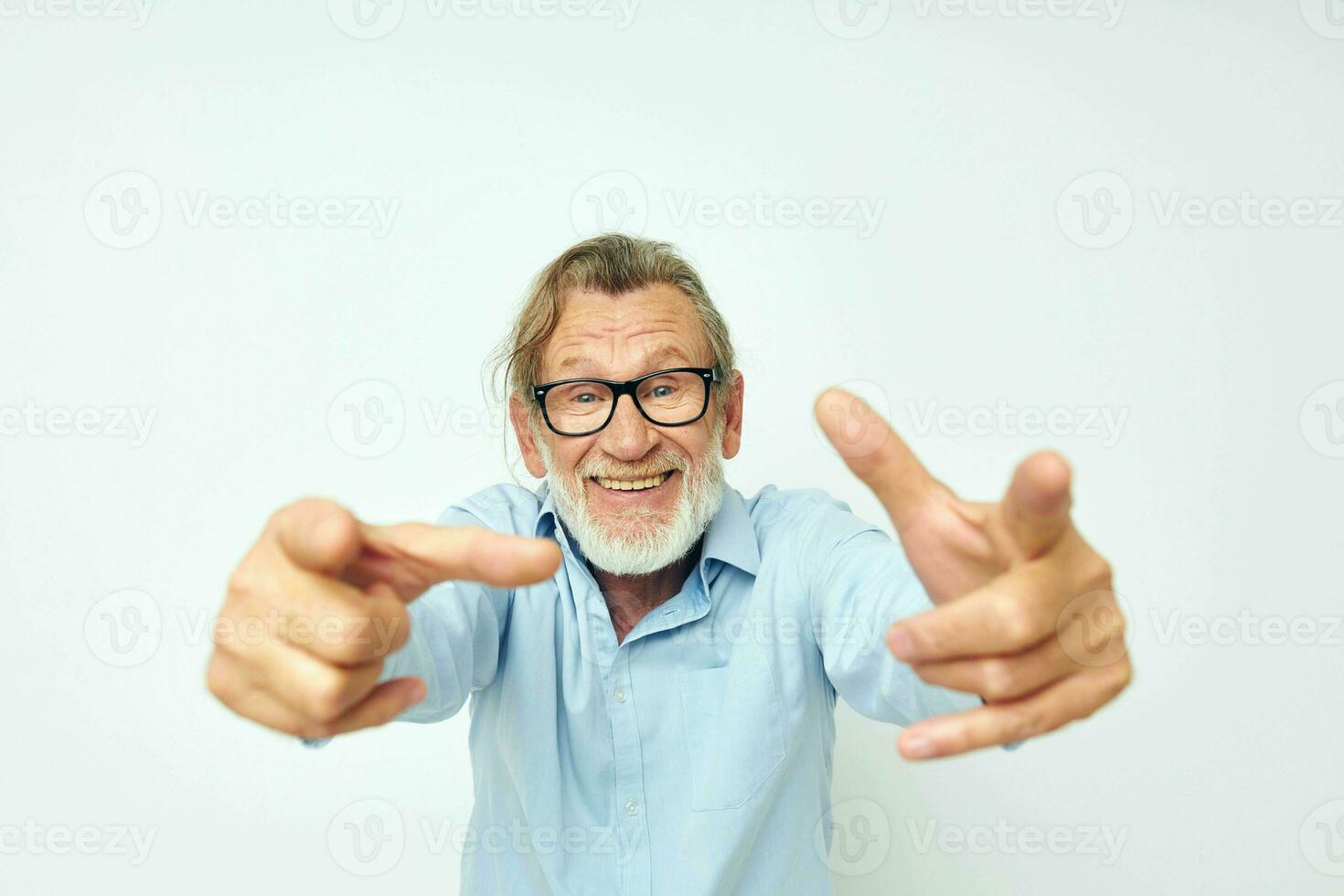 Portrait elderly man in blue shirts gestures with his hands isolated background photo