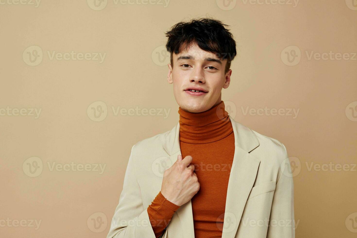 A young man mobile phone in the hands of communication in a suit fashion light background unaltered photo