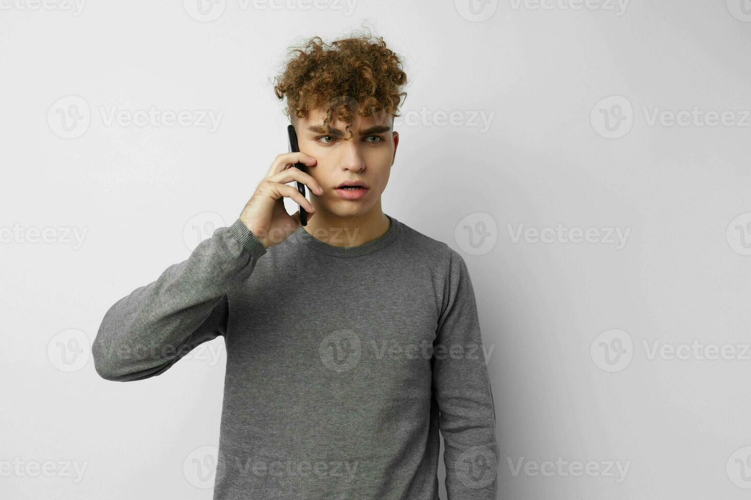 kinky guy talking on the phone posing emotions isolated background photo