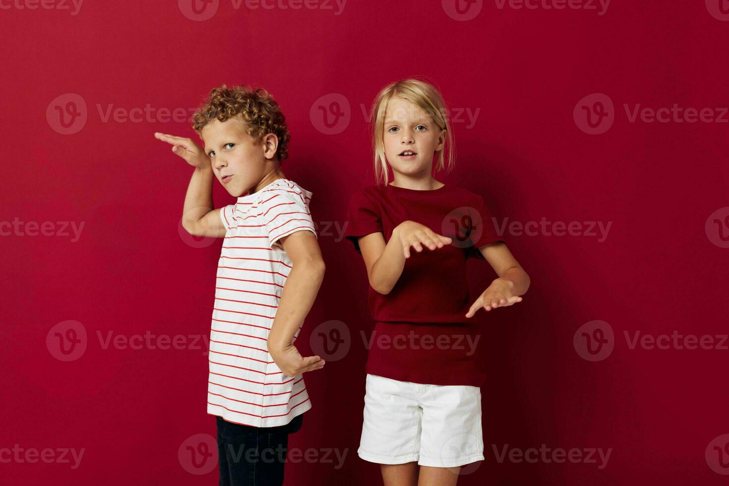 picture of positive boy and girl good mood standing next to posing isolated background photo