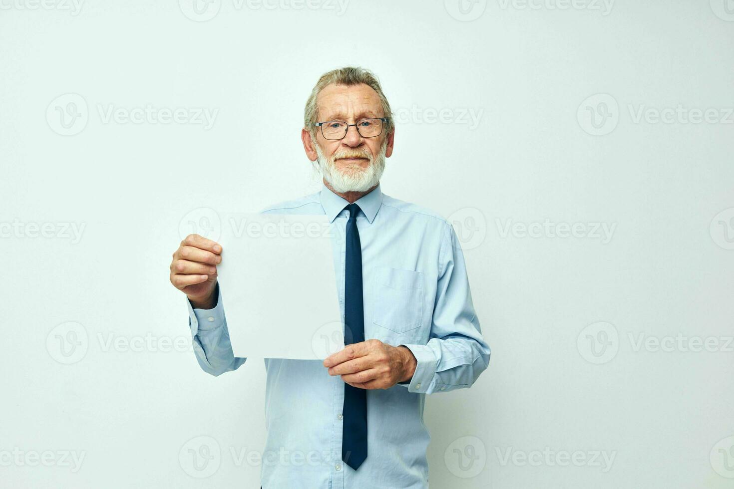 Senior grey-haired man in a shirt with a tie copy-space sheet of paper isolated background photo