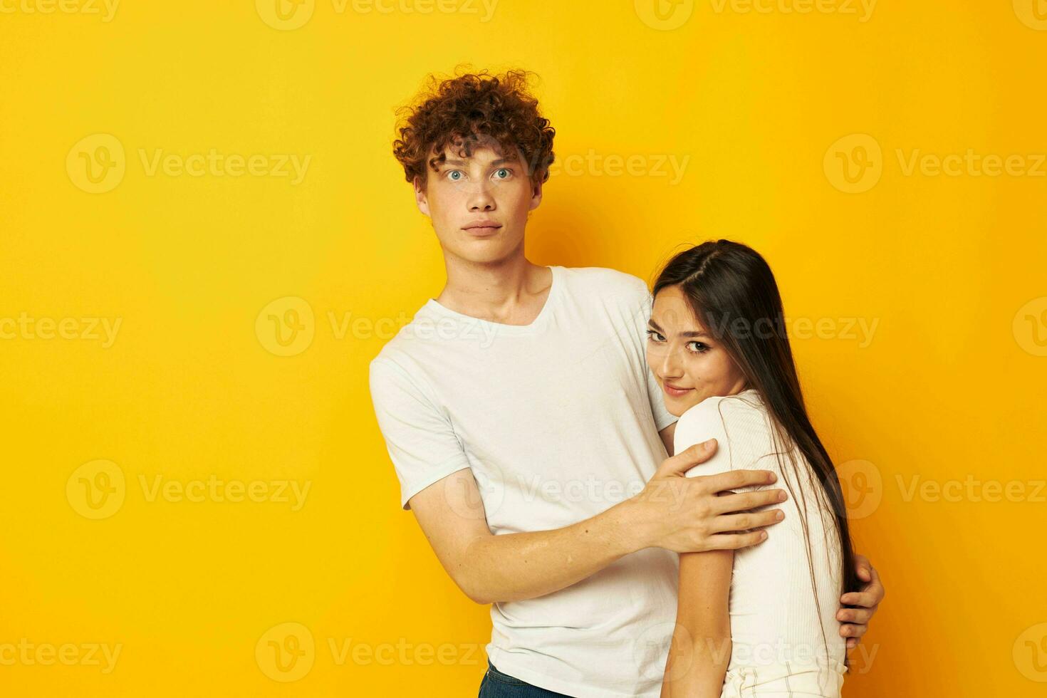 portrait of a man and a woman hug friendship relationship fun yellow background unaltered photo