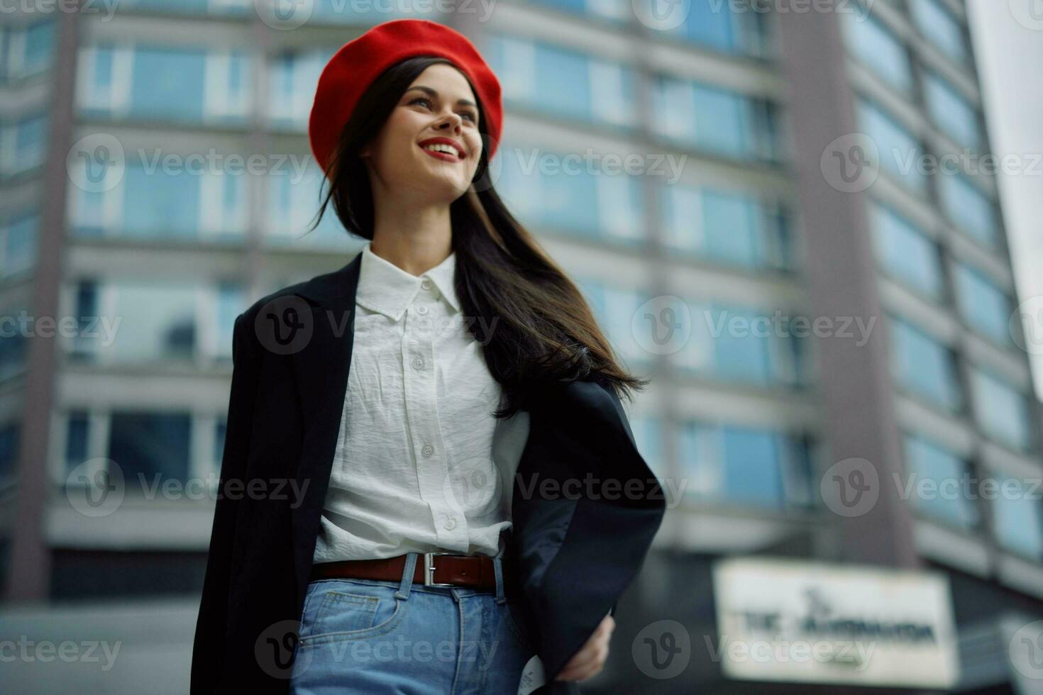 A business woman walks in the city against the backdrop of office buildings, stylish fashionable vintage clothes and make-up, spring walk, travel. photo
