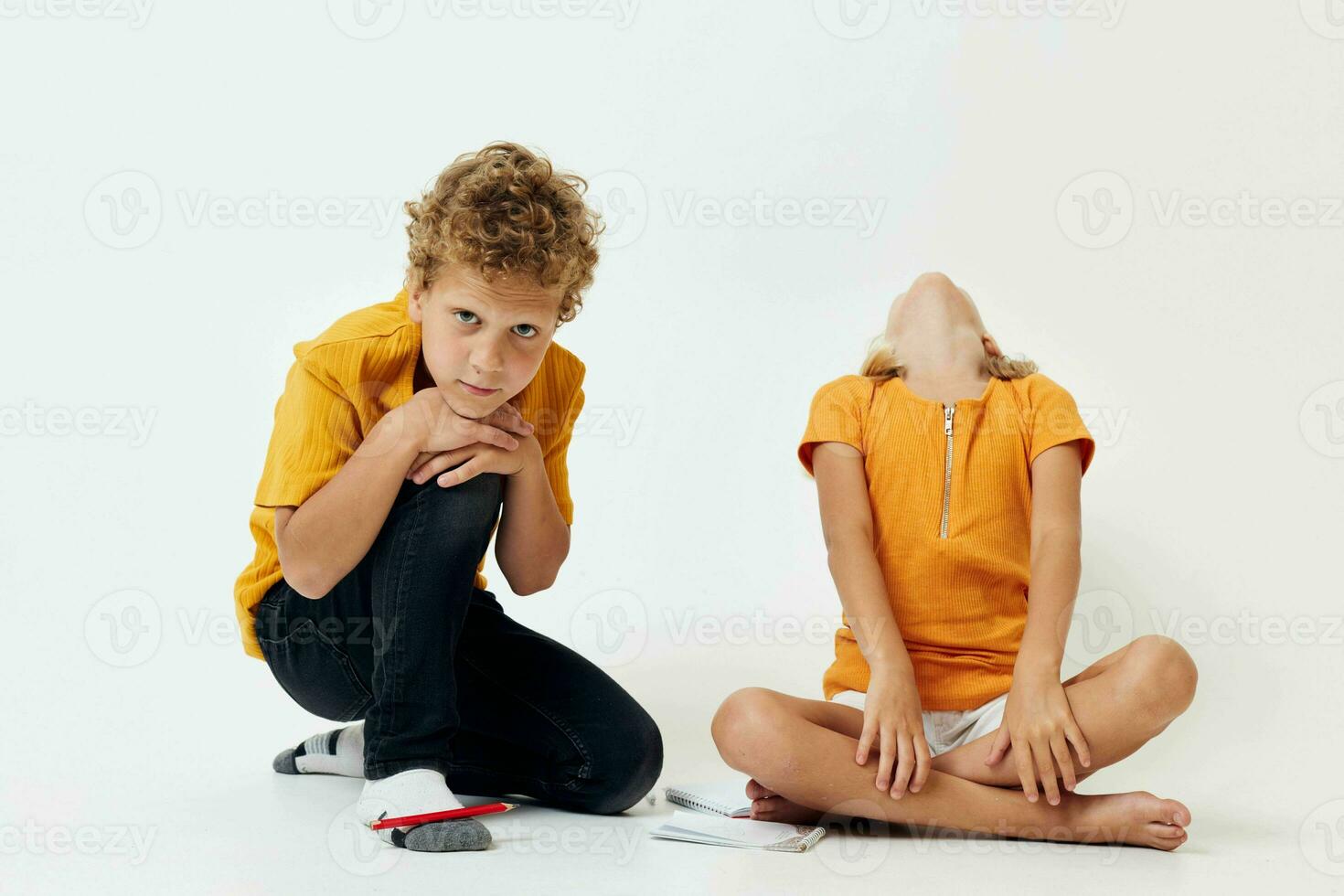 cute boy and girl in casual clothes studio full length posing photo