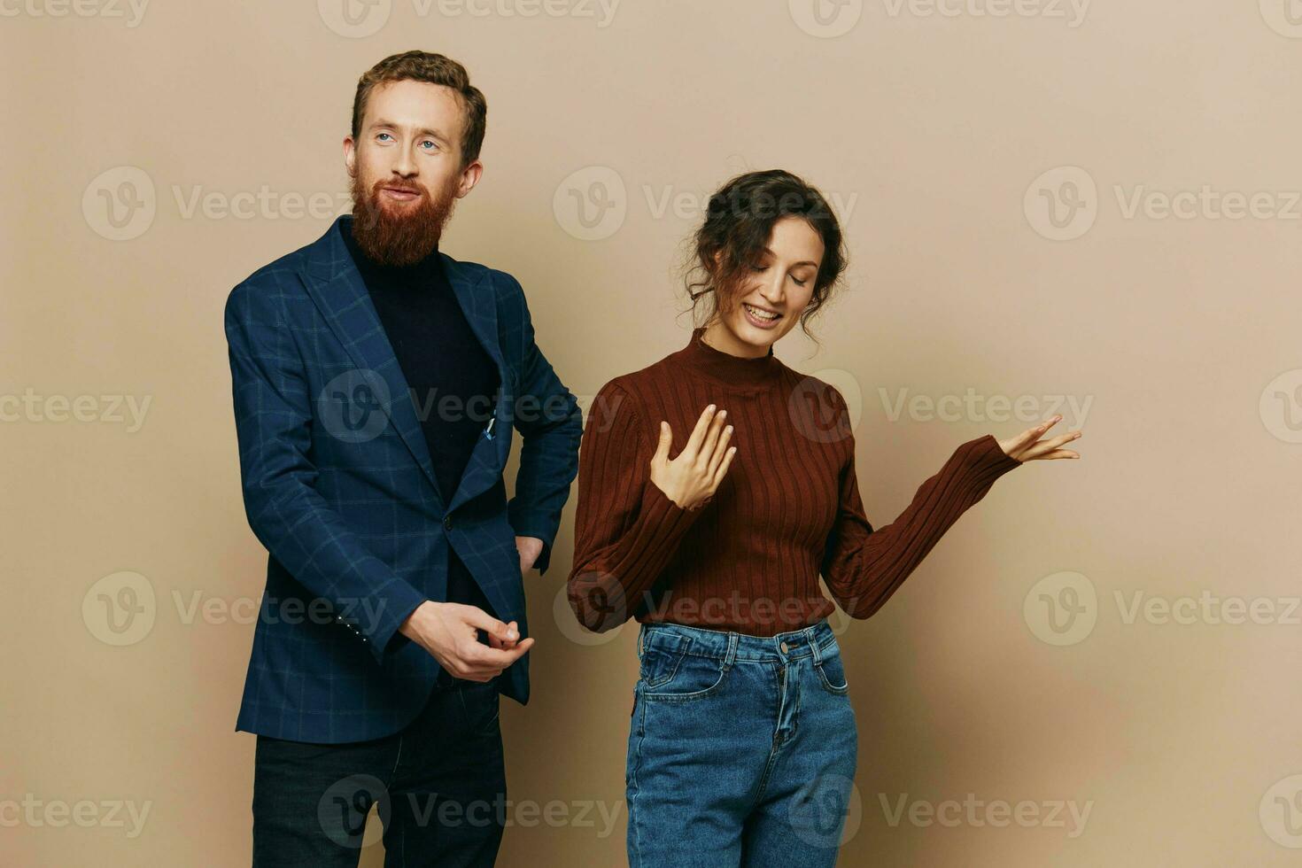 Man and woman couple in a relationship smile and interaction on a beige background in a real relationship between people photo