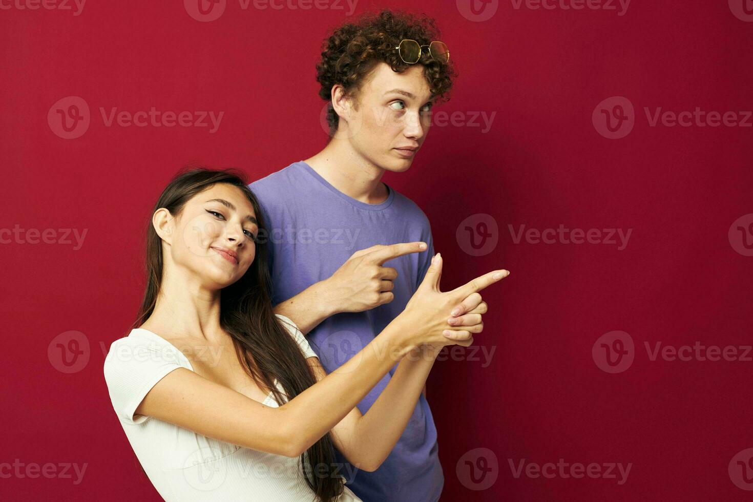young man and girl summer style posing fashion emotions red background photo