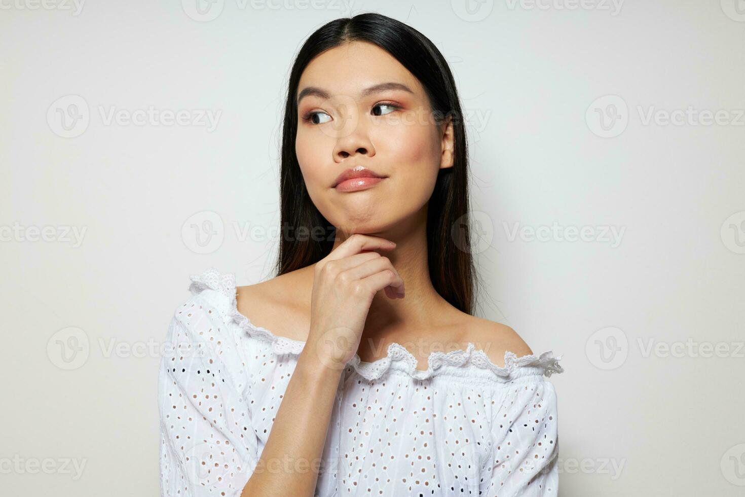 cheerful asian posing fashion studio model light background photo