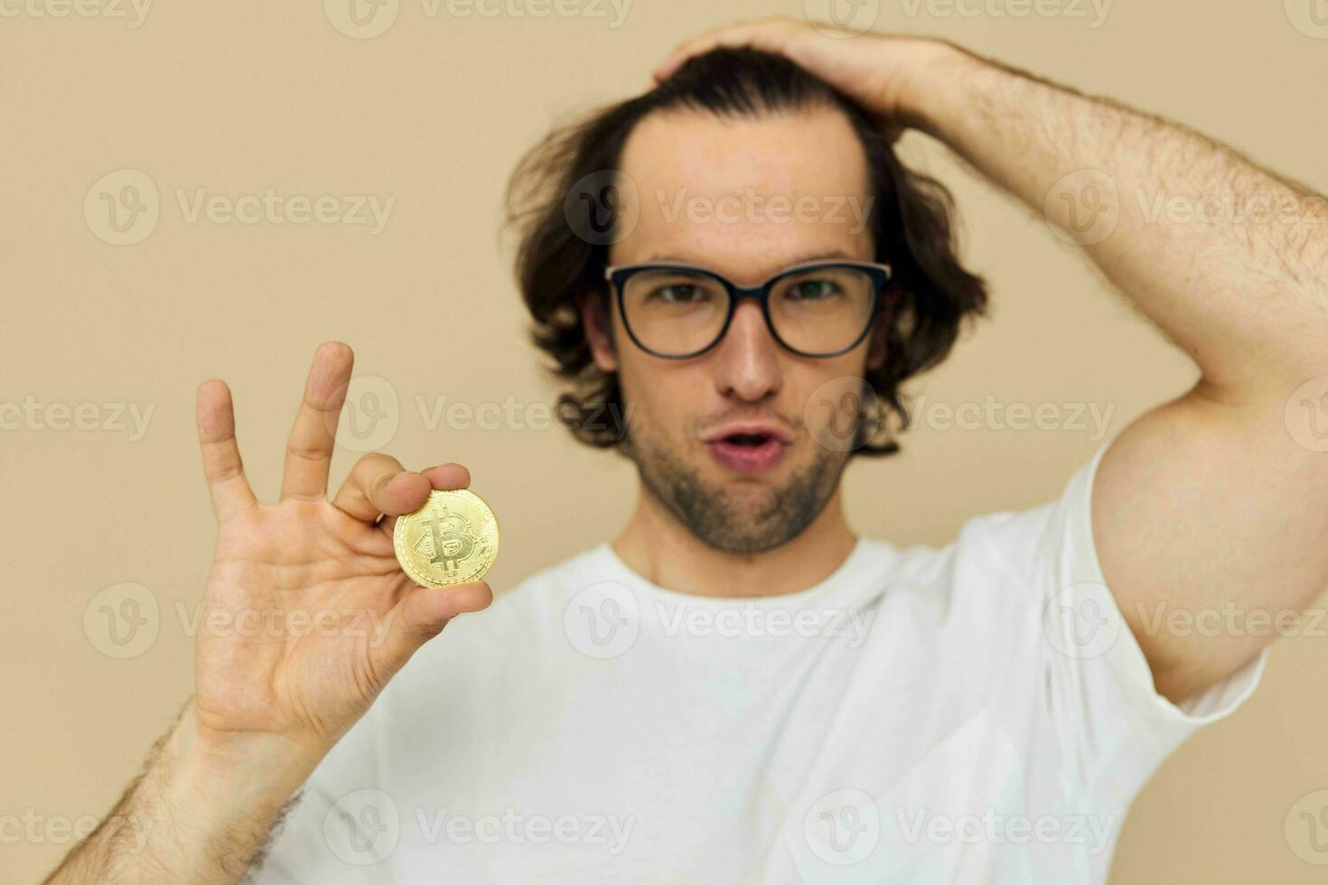 handsome man in a white T-shirt with Bitcoin cryptocurrency isolated background photo