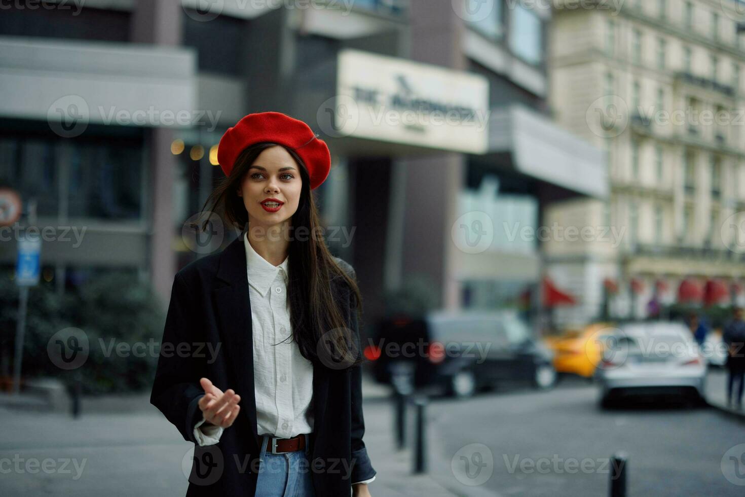 Woman smile with teeth tourist walks walks in the city on the background of office buildings, stylish fashionable clothes and make-up, spring walk, travel. photo
