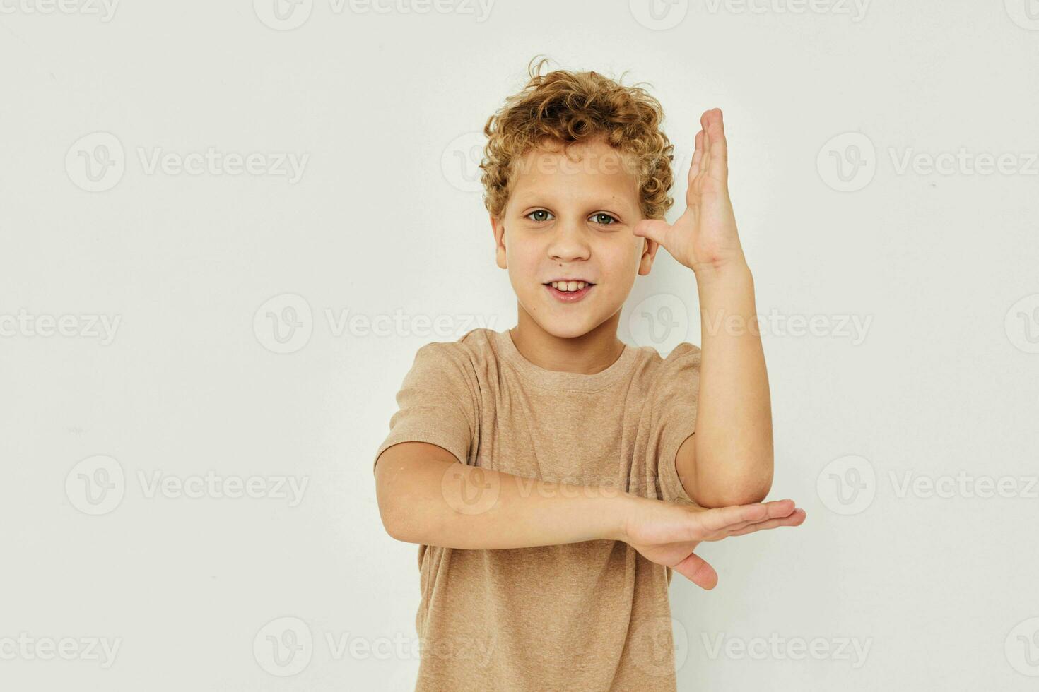 linda pequeño chico en un ligero antecedentes posando sonrisa foto