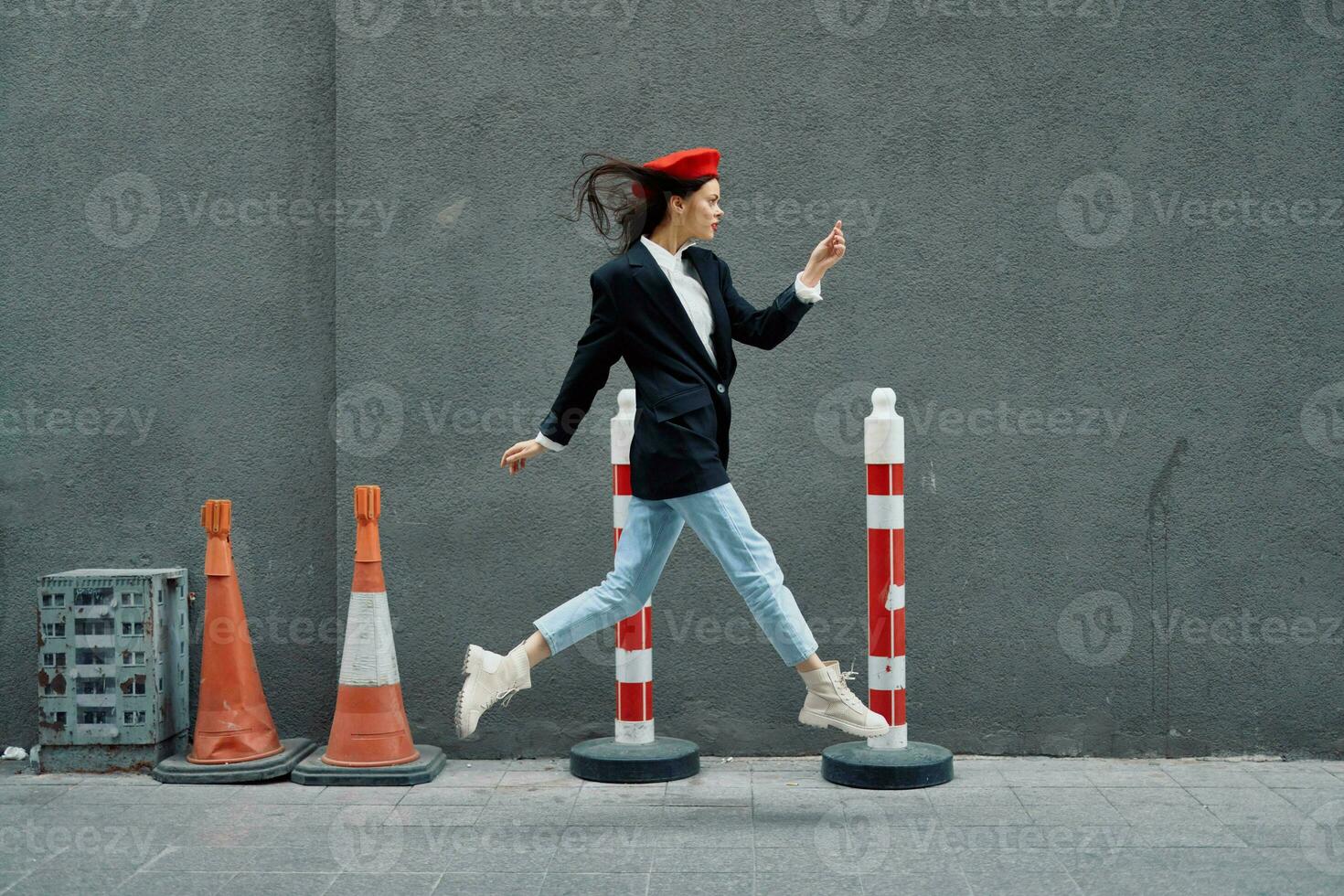 Fashion woman running down the street in front of the city tourist in stylish clothes with red lips and red beret, travel, cinematic color, retro vintage style, late to work, run. photo