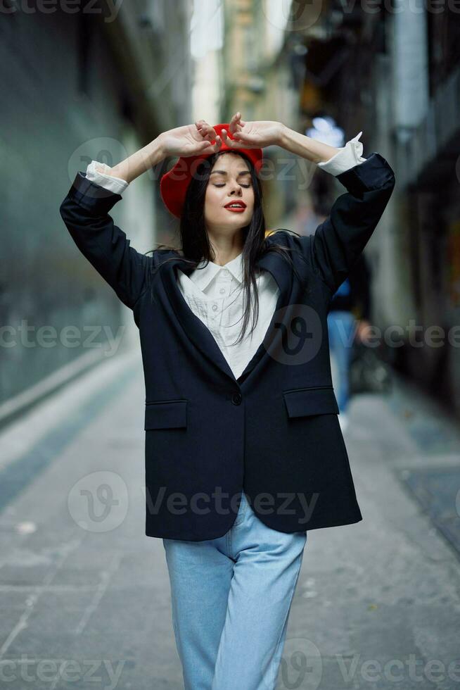 Fashion woman portrait walking tourist in stylish clothes with red lips walking down narrow city street, travel, cinematic color, retro vintage style, dramatic look without smile sadness. photo