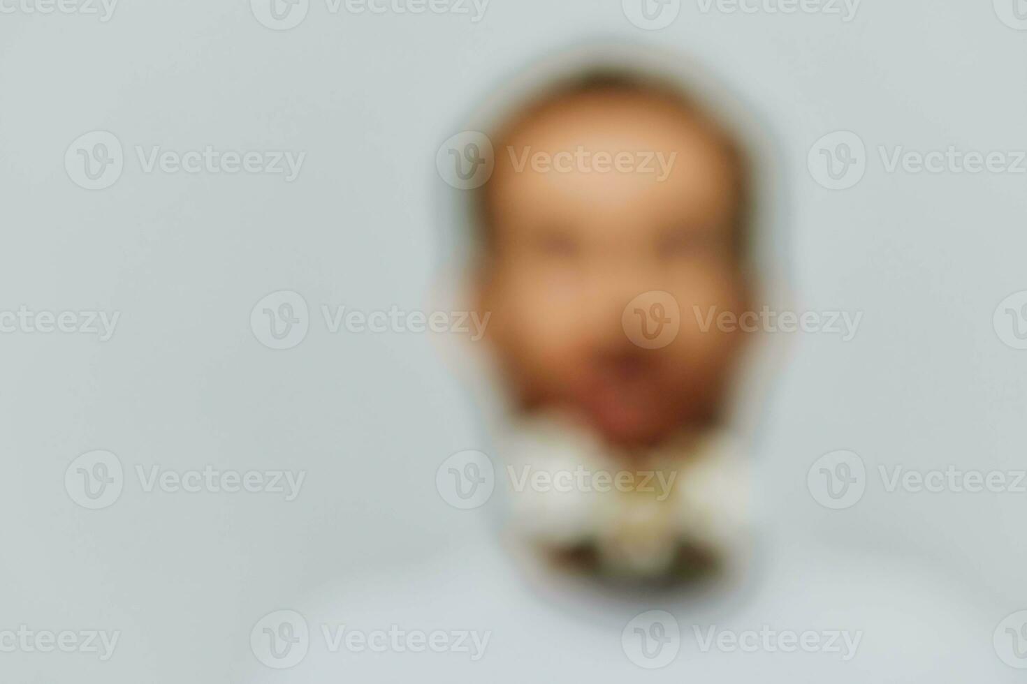 Portrait of a funny man in a white T-shirt with flowers daisies in his beard on a white isolated background, copy place. Holiday concept and congratulations. photo