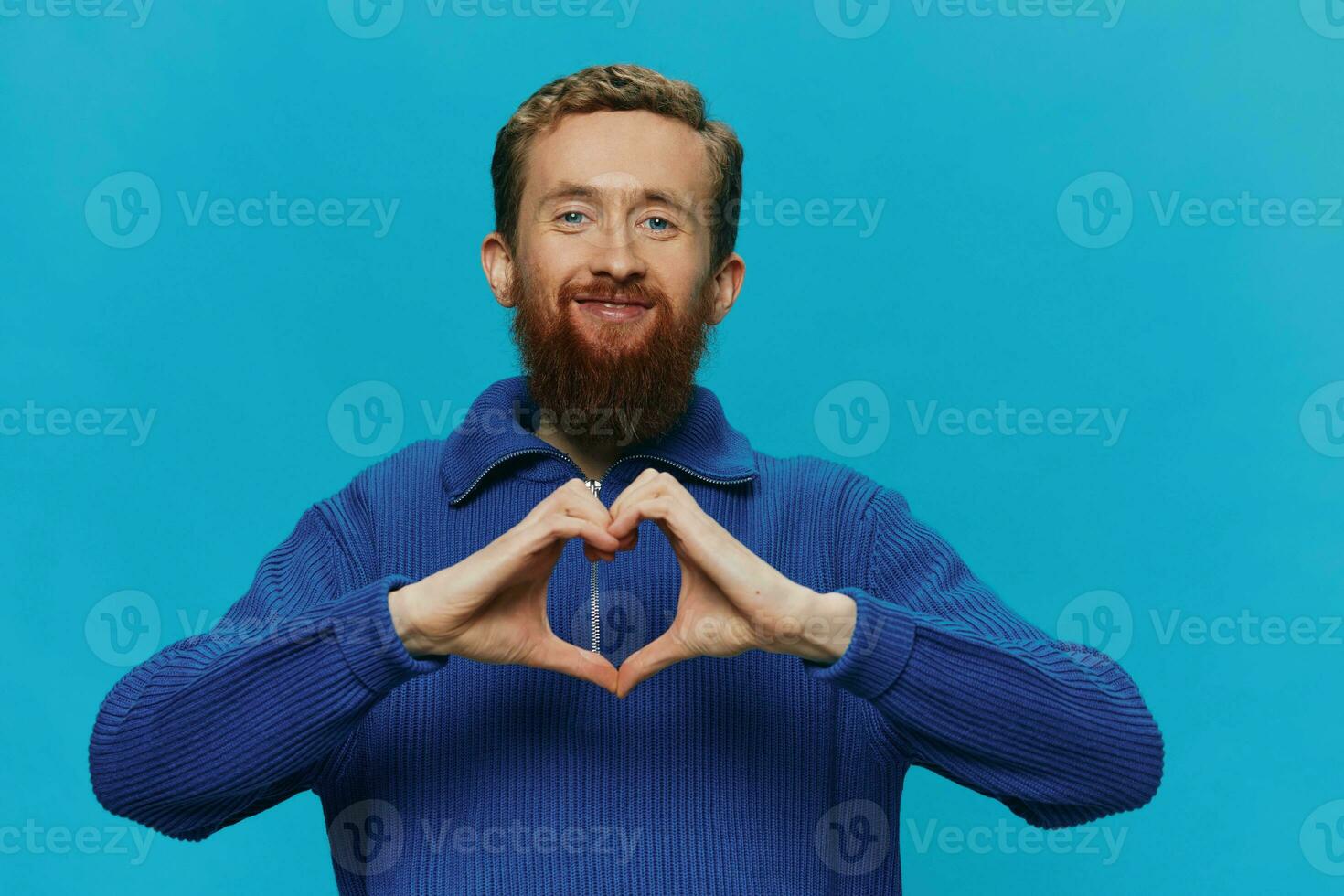 Portrait of a man in a sweater smile and happiness, hand signs and symbols, on a blue background. Lifestyle positive, copy place. photo