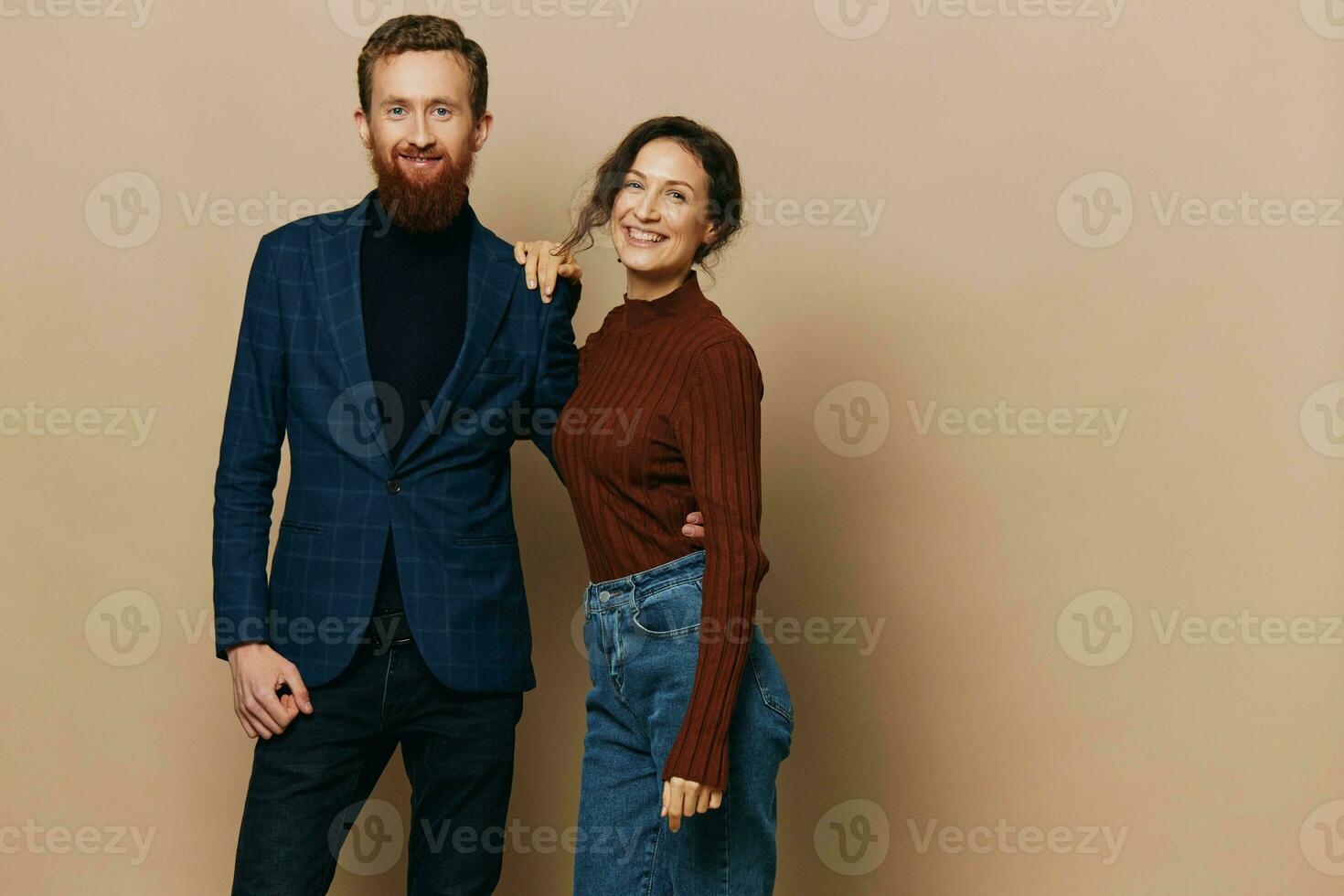 Man and woman couple in a relationship smile and interaction on a beige background in a real relationship between people photo