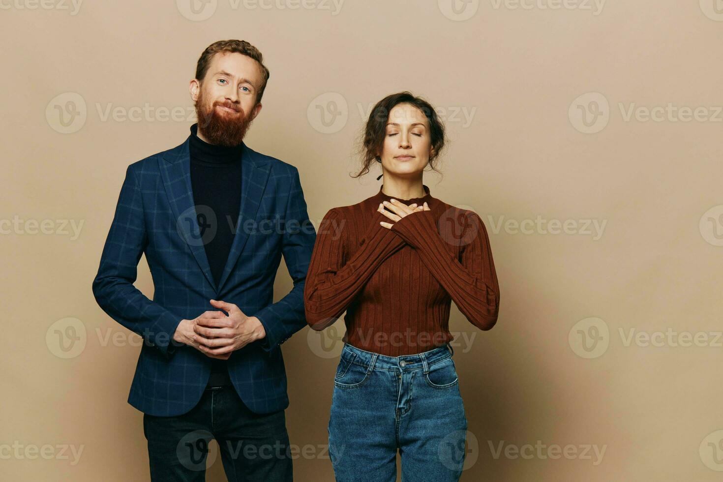 Man and woman couple in a relationship smile and interaction on a beige background in a real relationship between people photo