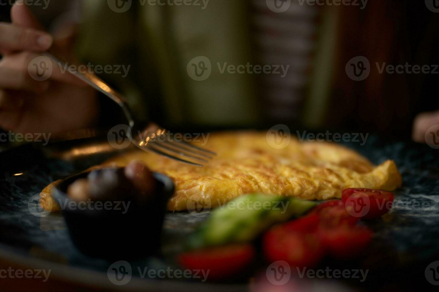 Woman in cafe eating breakfast omelet with vegetables close-up of fork with food, home-cooked food in restaurant, social media content photo