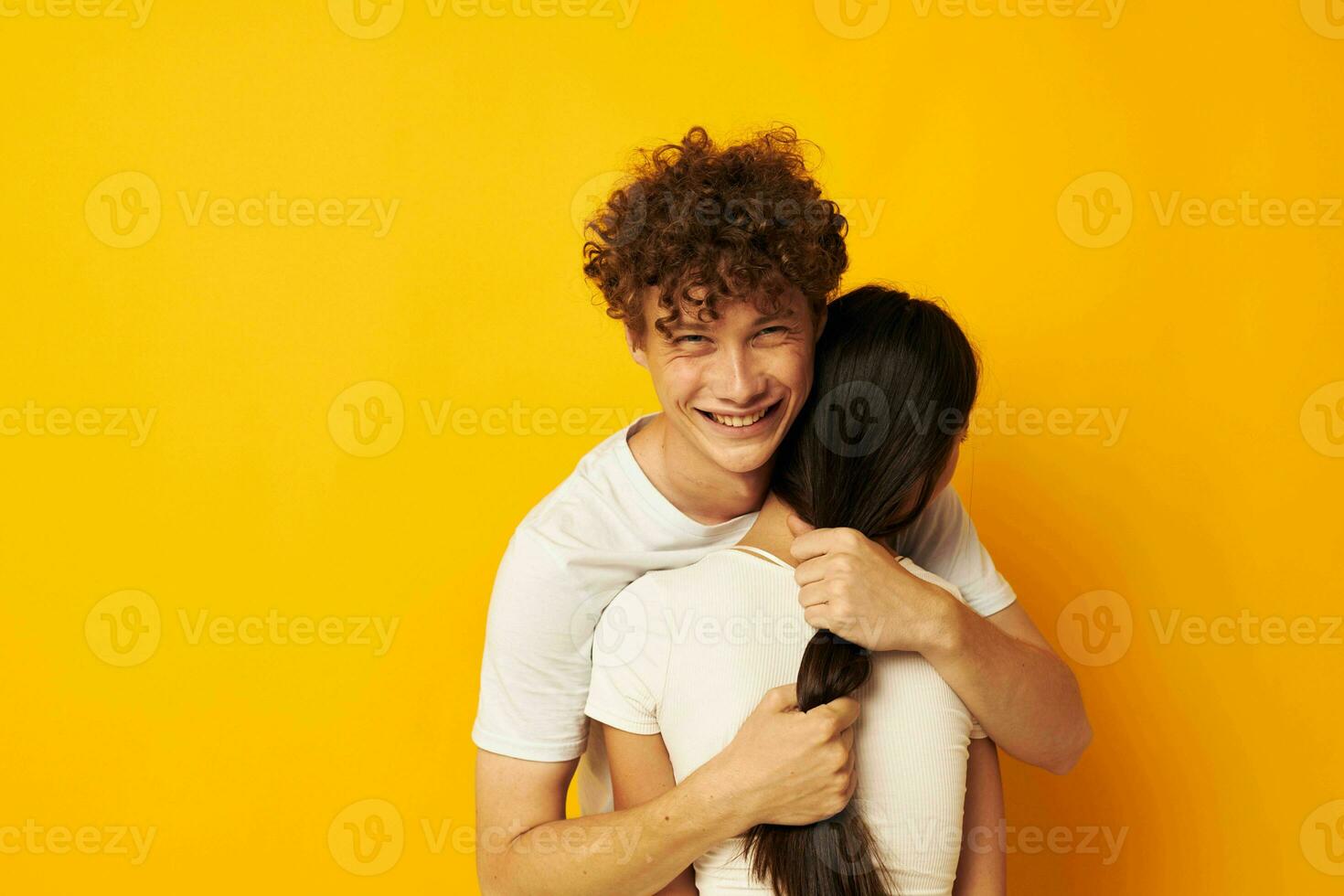 teenagers hug friendship relationship fun yellow background unaltered photo