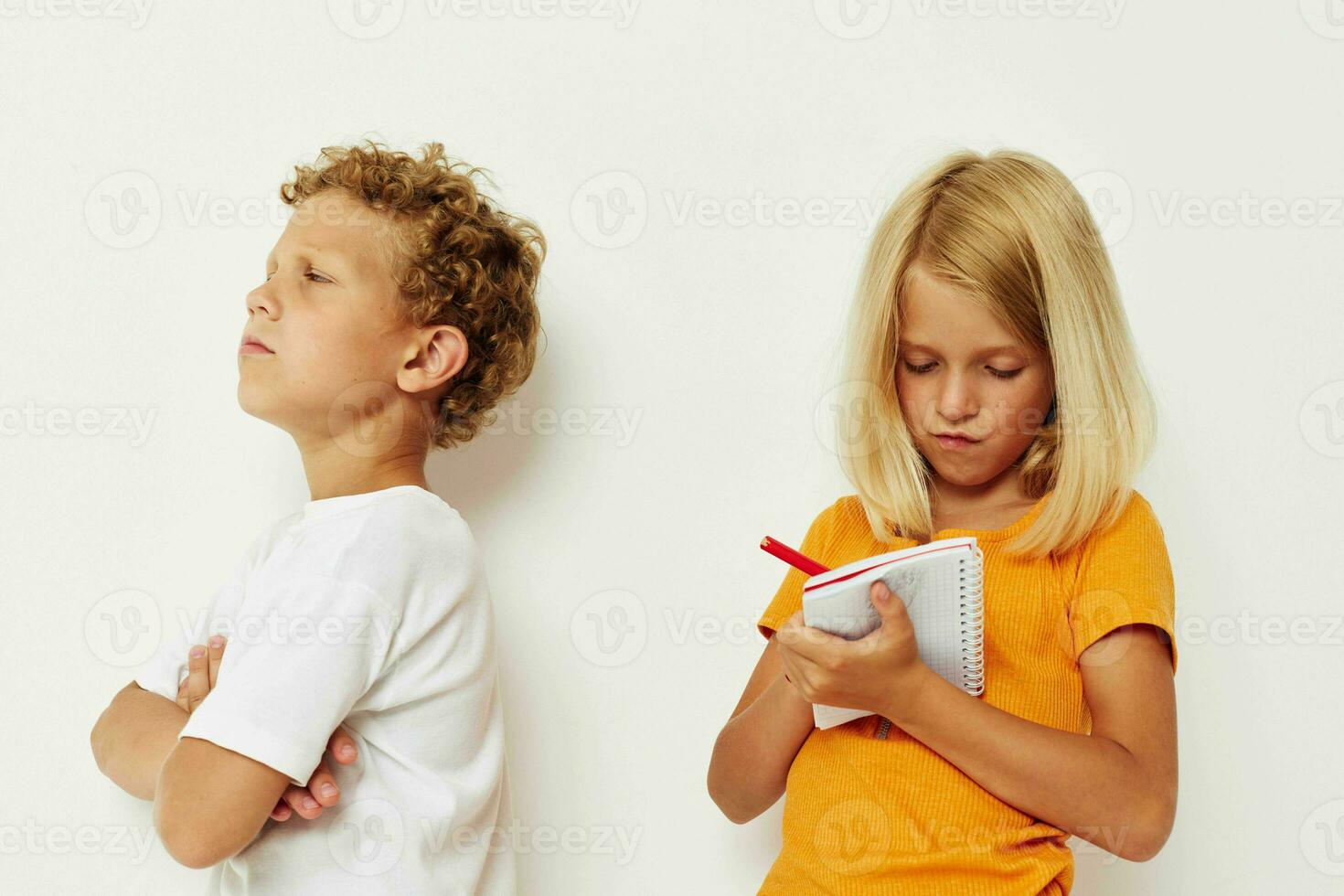 two joyful children stand next to notepad pencil drawing emotions lifestyle unaltered photo