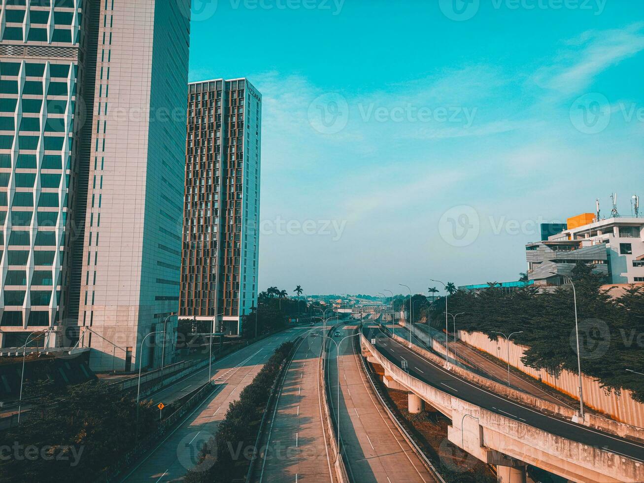 A modern office building with clear blue sky with street view photo