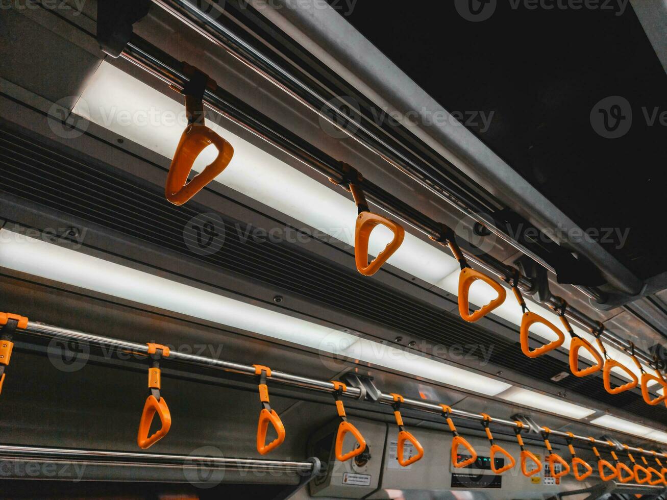 Empty yellow handle grip on public transportation photo