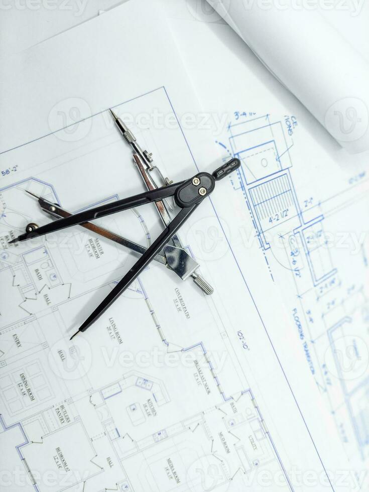 Paper home floor plan with compass. Architectural sketching process concept. Floor plan on architect's desk. photo